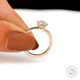 Handheld view of round moissanite solitaire ring