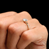 Side angle of moissanite solitaire ring on hand