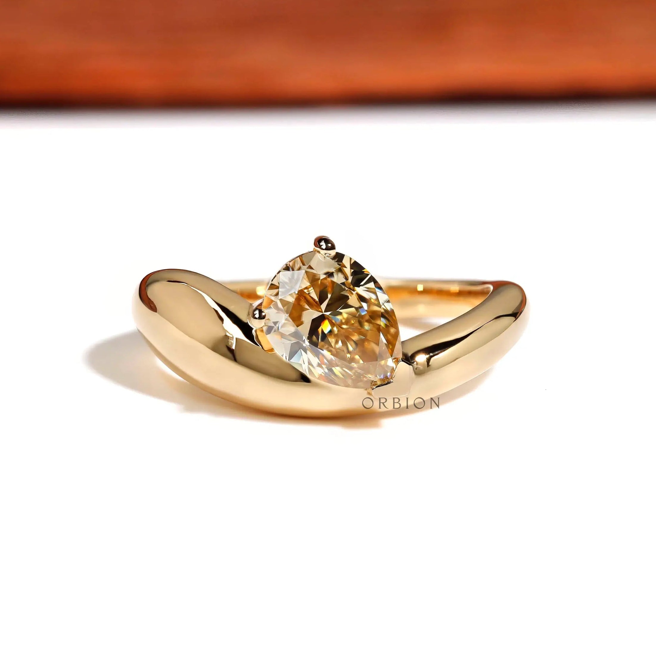 Chunky pear moissanite ring with bold yellow gold band