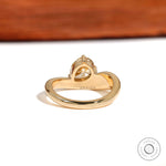 Rear view highlighting thick gold band and sculpted setting