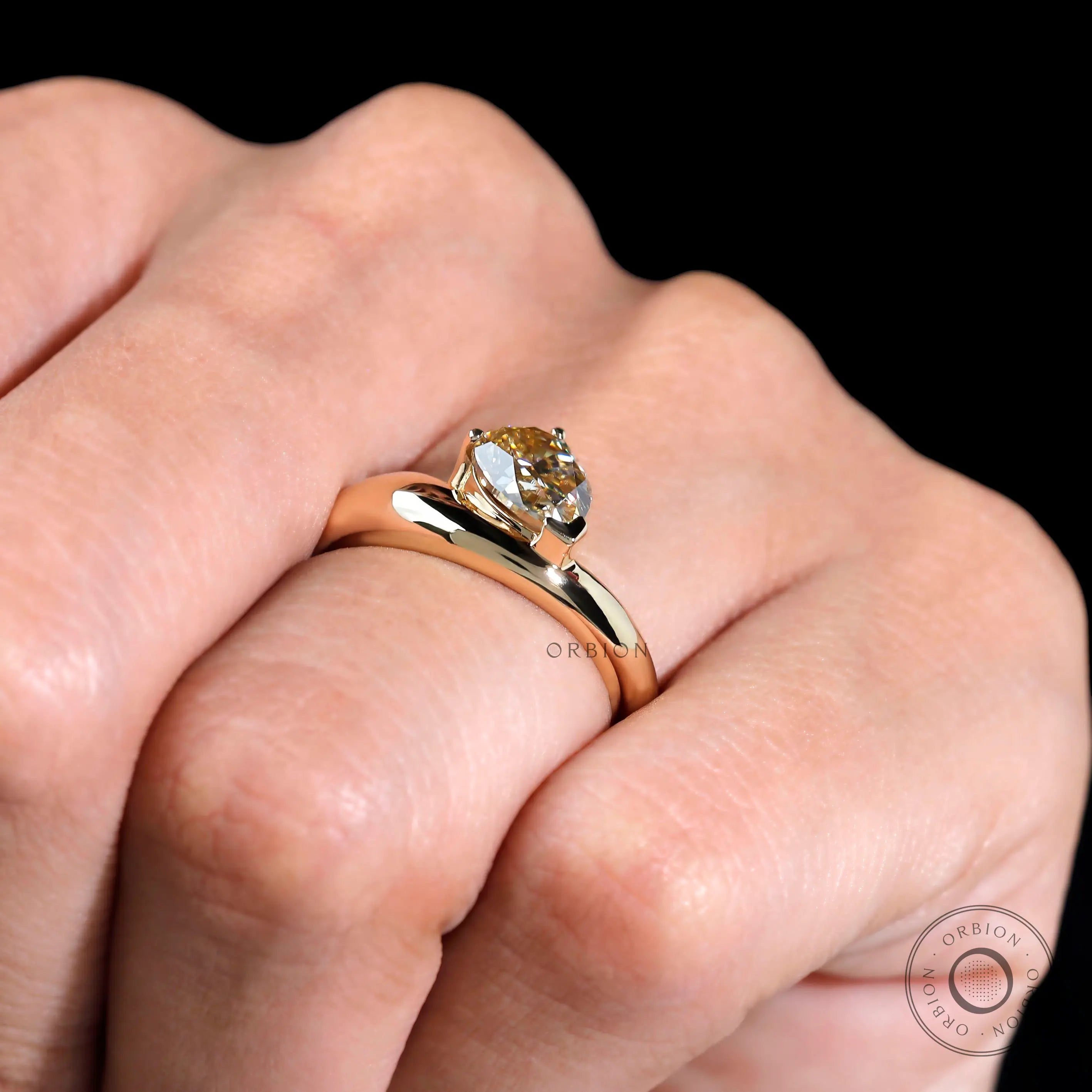Hand shot showcasing chunky pear moissanite statement ring