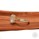 Side profile highlighting tulip basket setting and slim polished gold band.