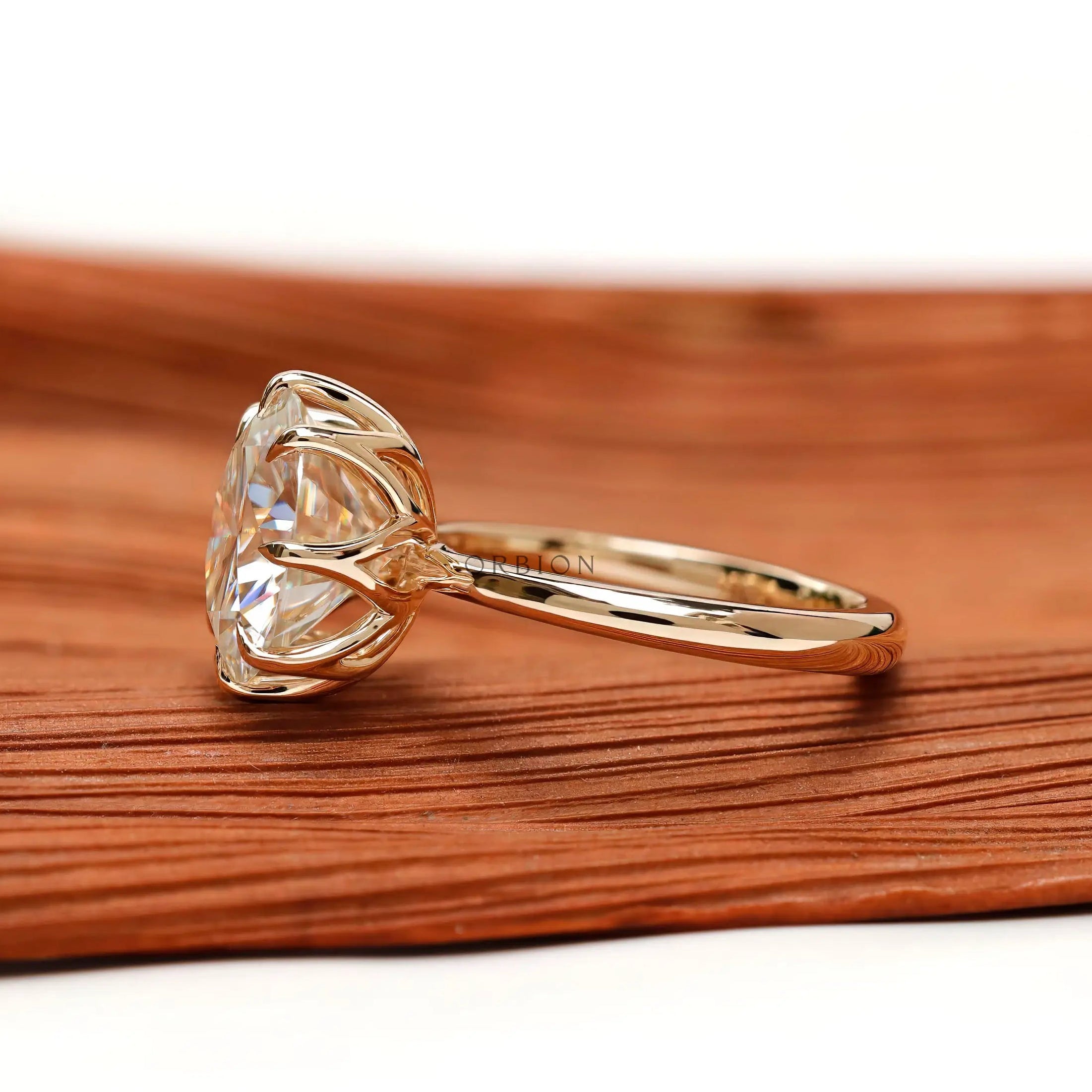 Side profile highlighting tulip basket setting and slim polished gold band.