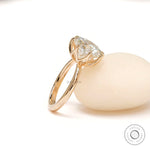 Angled view showcasing elevated basket and bold 11 mm round solitaire.