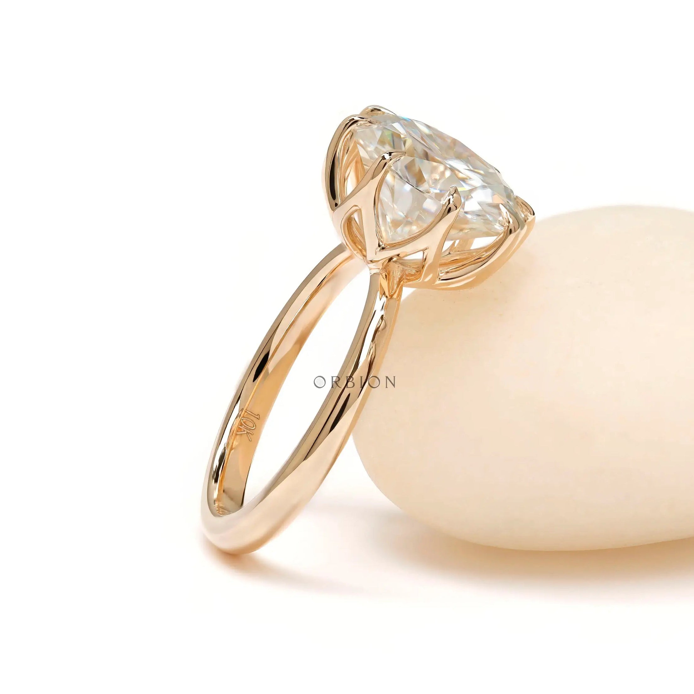Angled view showcasing elevated basket and bold 11 mm round solitaire.