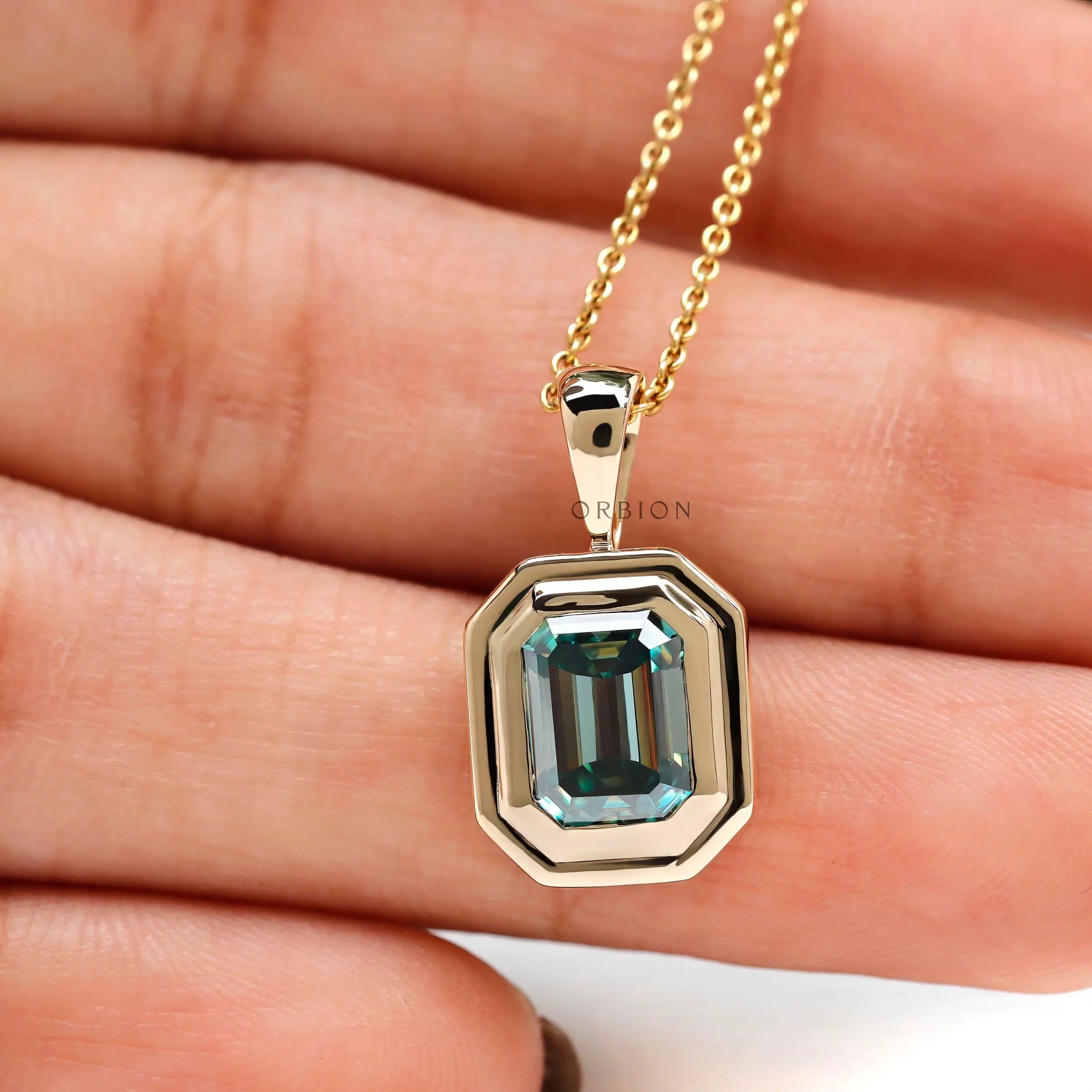 Solid gold emerald shaped teal moissanite solitaire pendant glossy finish