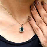 Blue green moissanite statement pendant on model