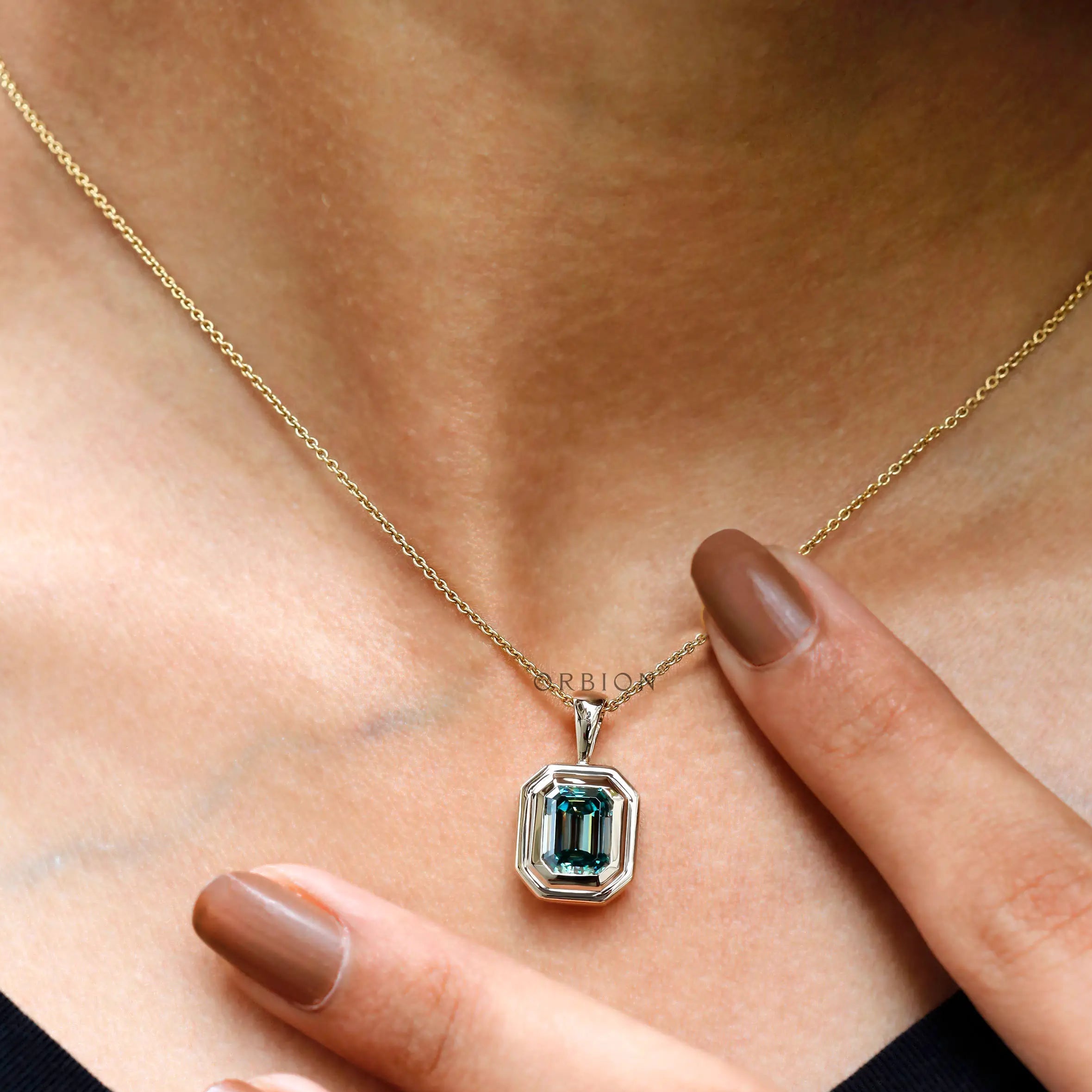 Emerald cut blue green moissanite bezel set pendant