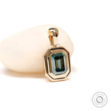 Emerald cut blue green moissanite bezel set pendant in 14k yellow gold