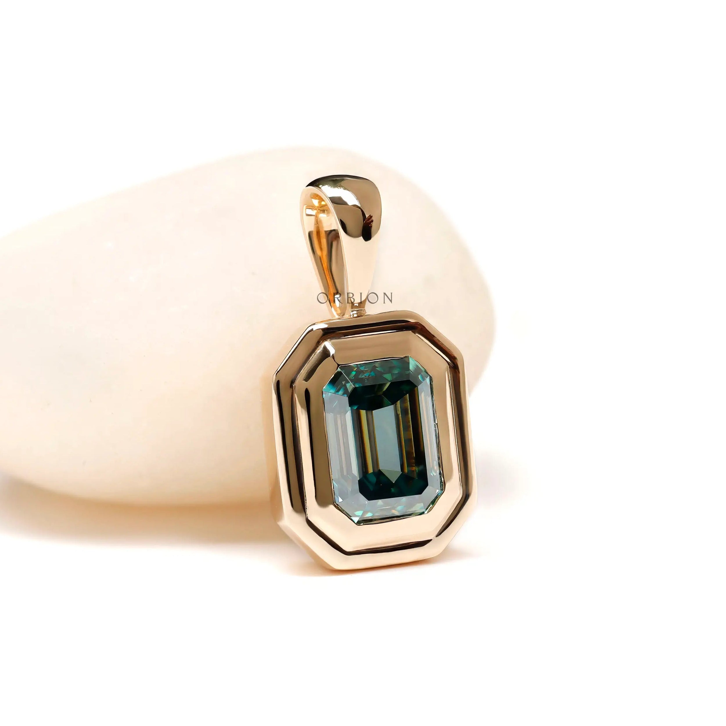 Emerald cut blue green moissanite bezel set pendant in 14k yellow gold