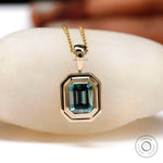 Step cut emerald moissanite solitaire gold necklace close view
