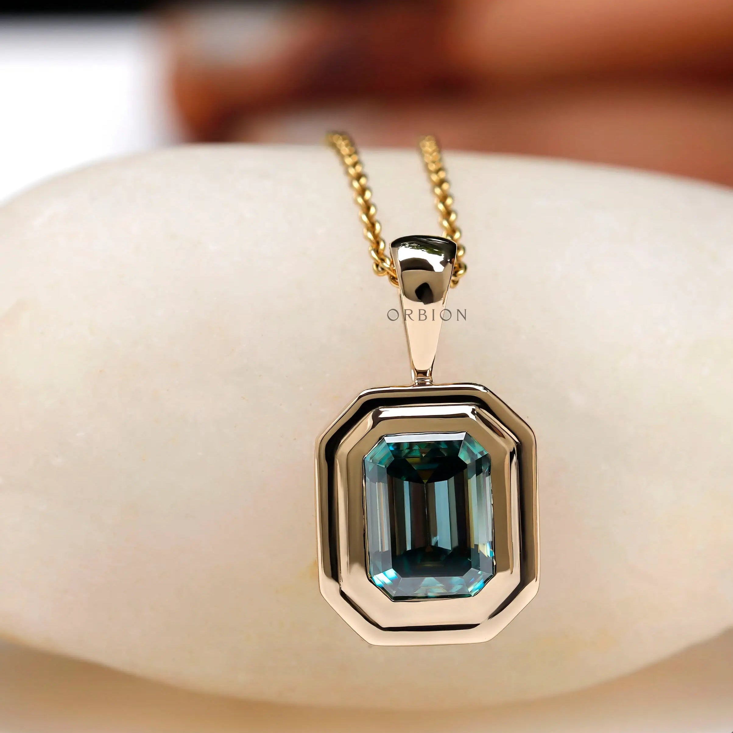Step cut emerald moissanite solitaire gold necklace close view
