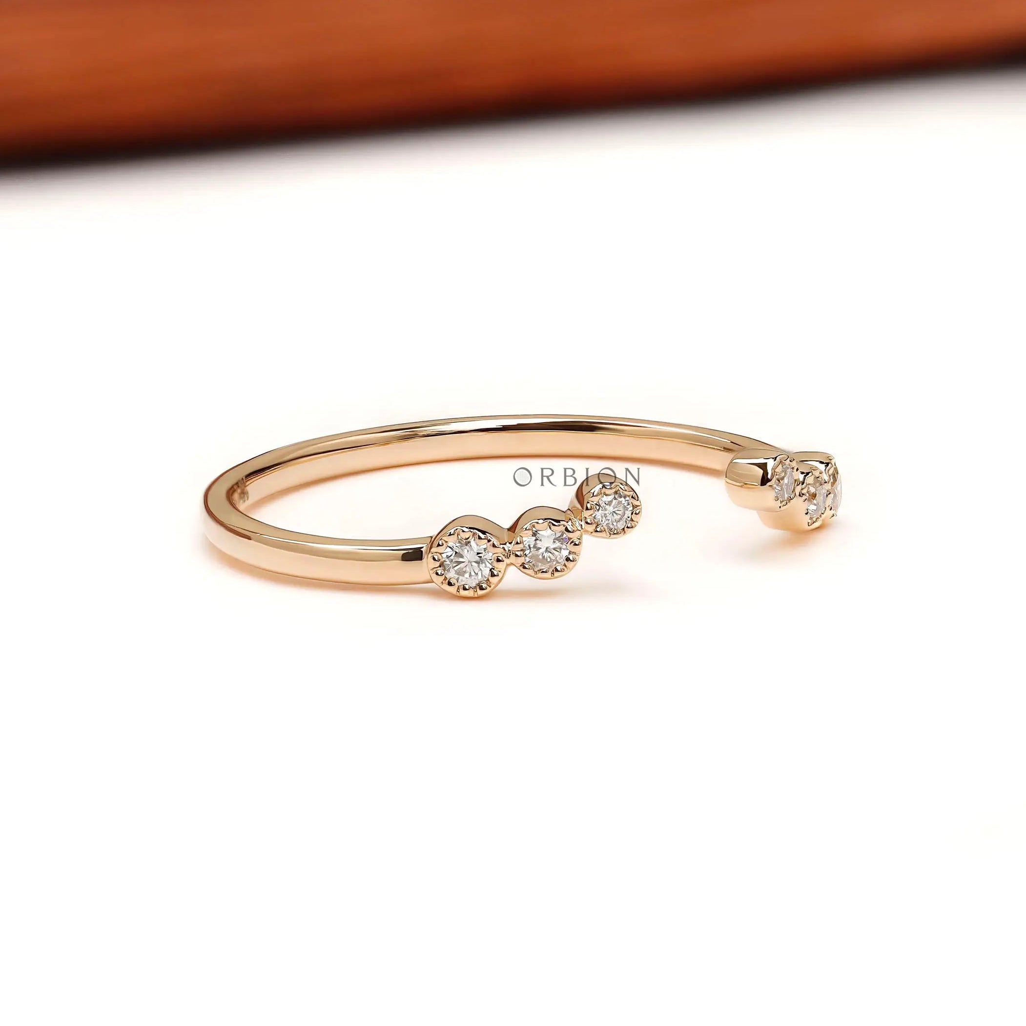 Unique open curved diamond band, angled perspective showing diamond clusters