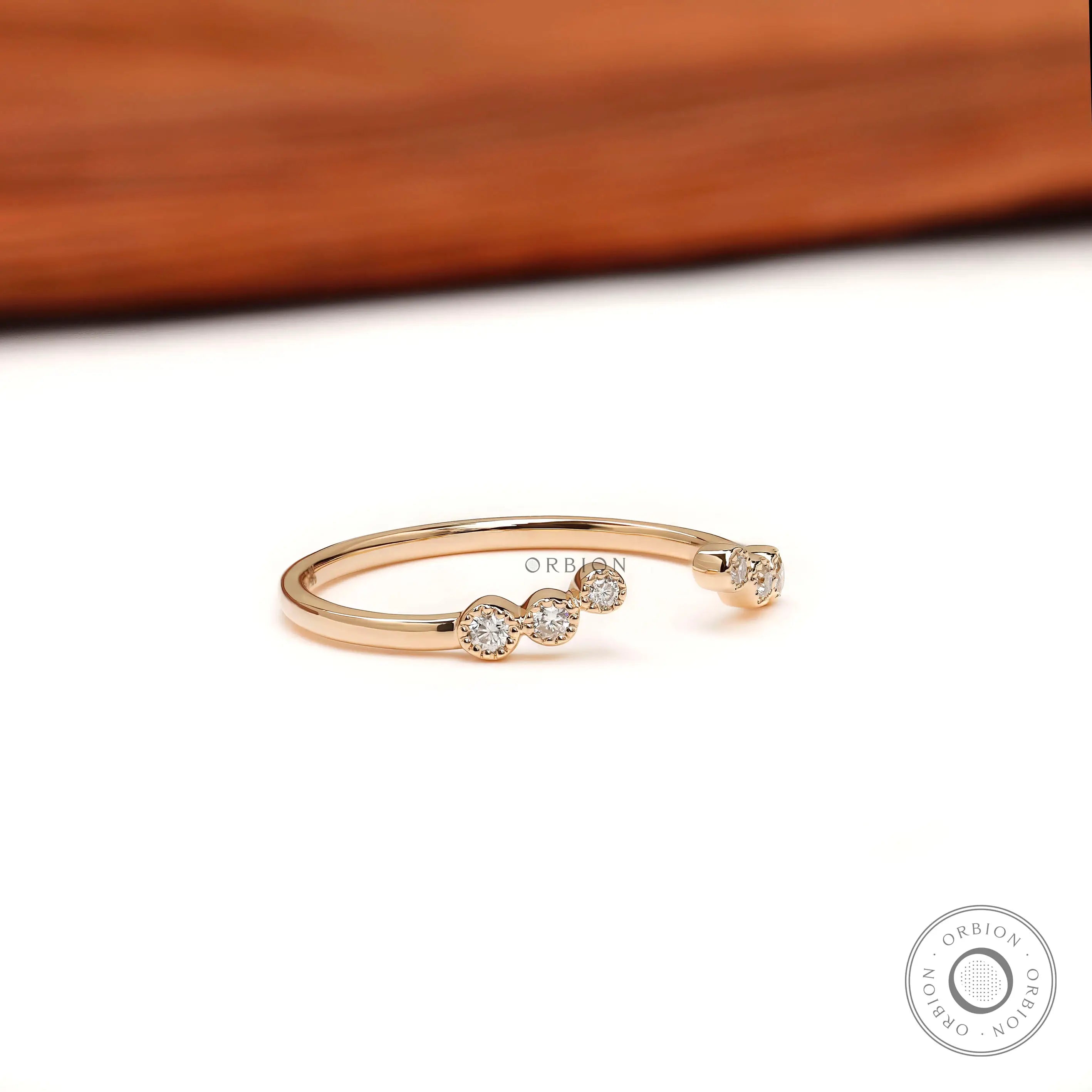 Unique open curved diamond band, angled perspective showing diamond clusters