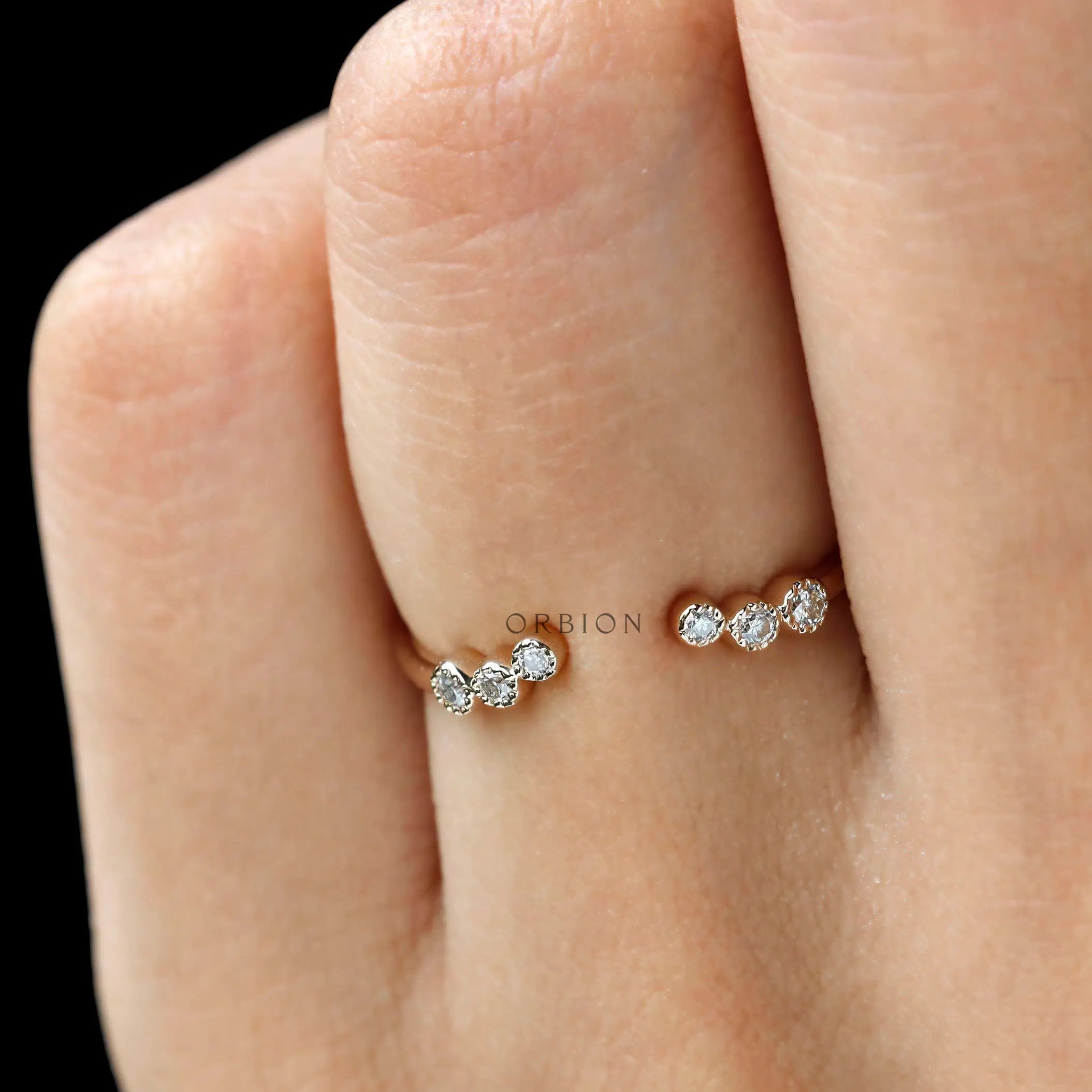Delicate open diamond band stacked on hand, modern bridal look