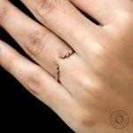 Open curved yellow gold diamond ring styled on hand, stacking inspiration