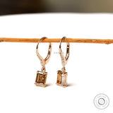 Emerald cut champagne moissanite drop earrings with round diamond accents yellow gold
