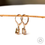emerald cut dark champagne and round moissanite dangling earrings yellow gold