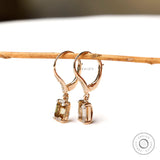emerald cut dark champagne and round moissanite dangling earrings yellow gold