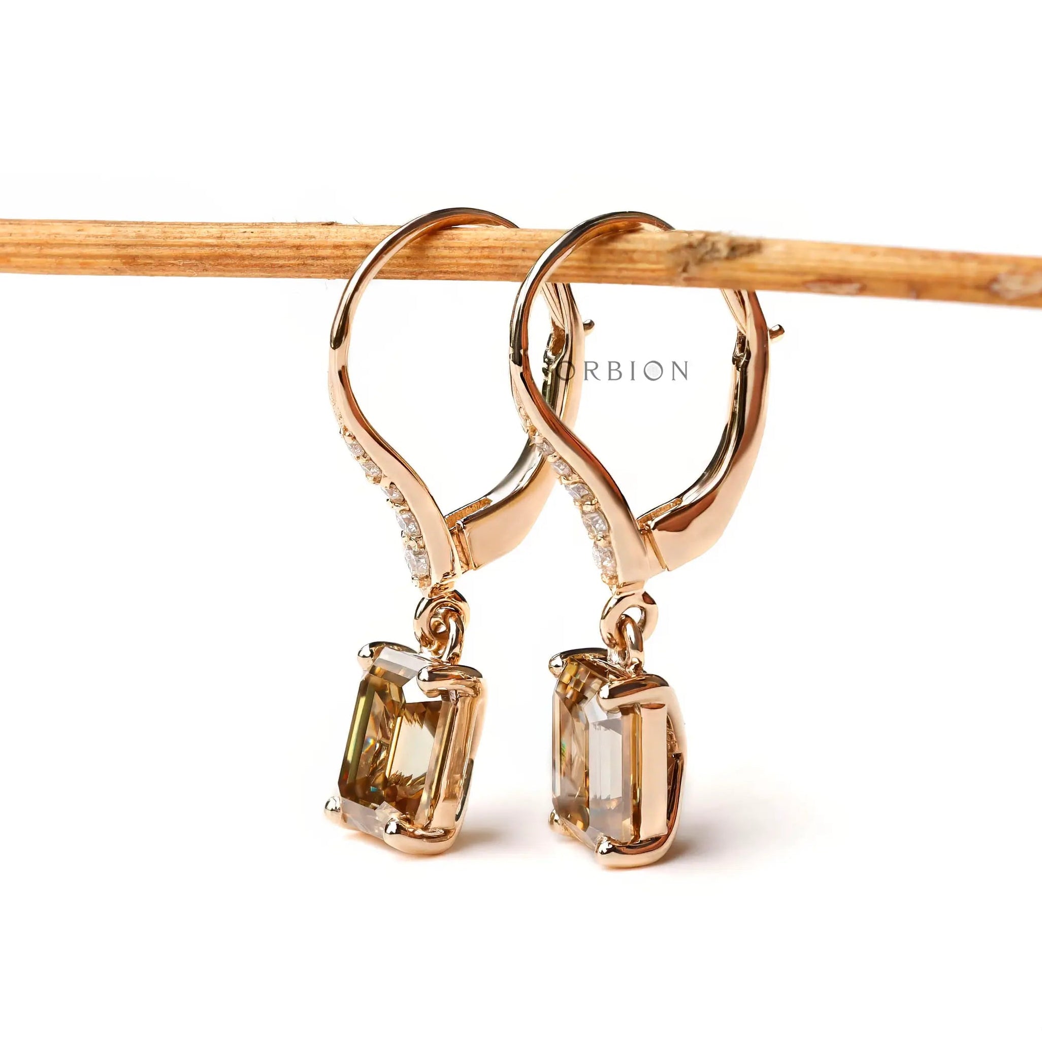 emerald cut dark champagne and round moissanite dangling earrings yellow gold