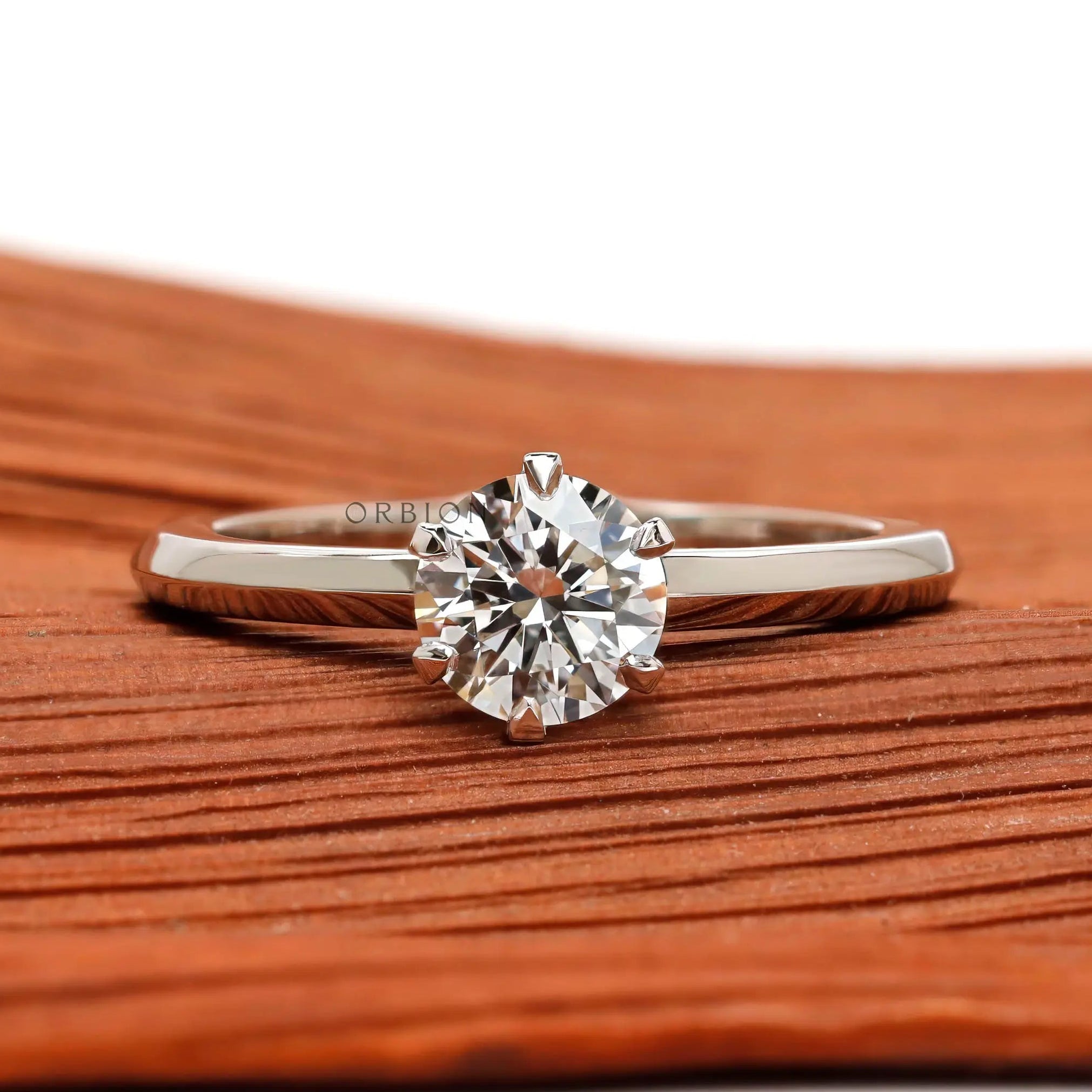Round cut solitaire engagement ring in 10K white gold front view