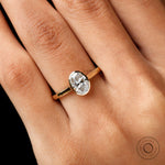 Close-up of oval lab diamond bezel in yellow gold
