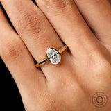 Close-up of oval lab diamond bezel in yellow gold