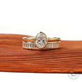 Front view of oval solitaire ring set with baguette band