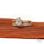 Angled front view of oval solitaire ring set in gold