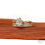 Angled front view of oval solitaire ring set in gold