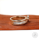 Side view of oval solitaire ring with channel baguette band