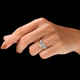 Angled hand shot of oval bezel ring with stack band