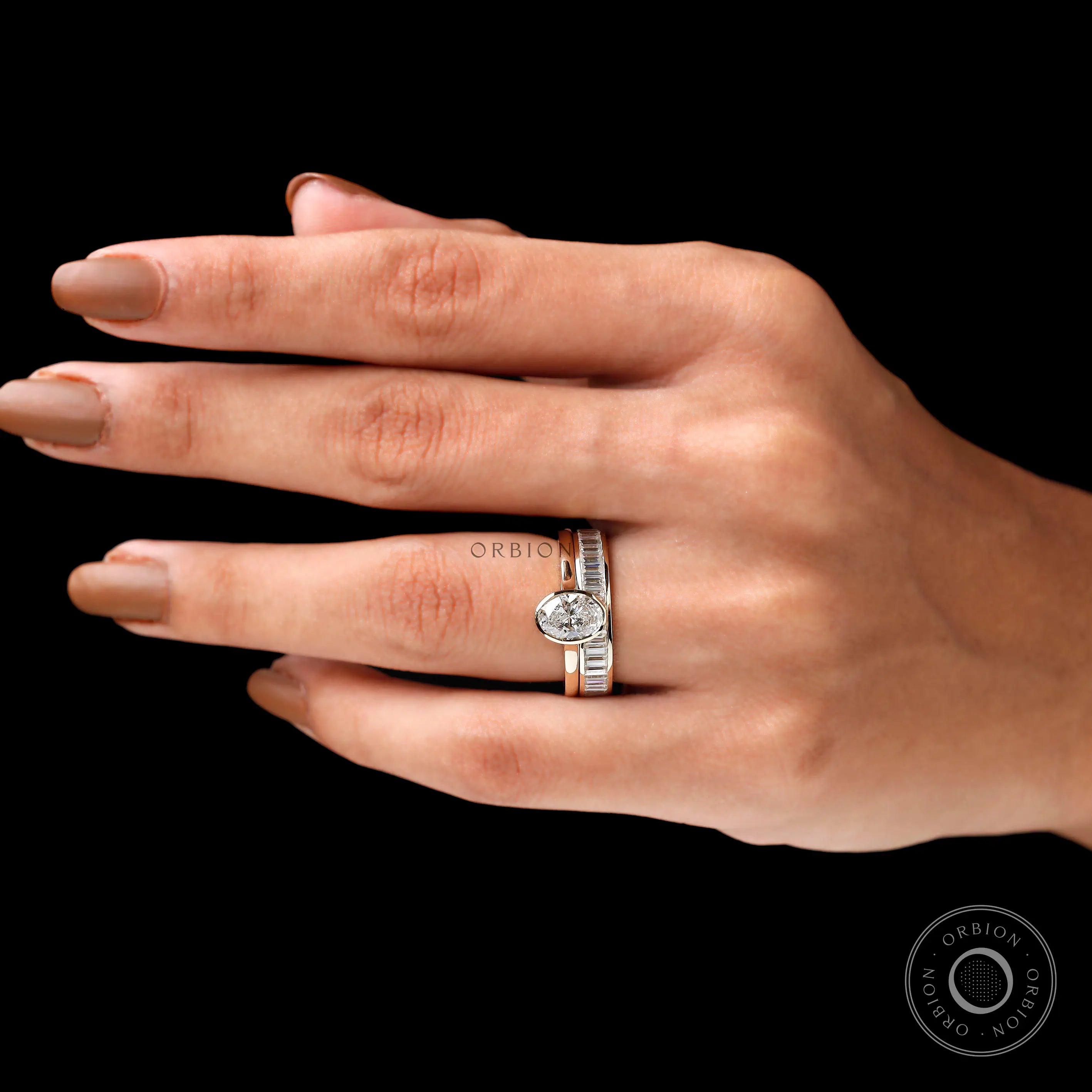 Top worn view of oval solitaire ring set on hand
