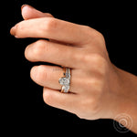 Angled worn view of oval solitaire ring set on hand