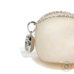 Eight prong round solitaire pendant in white gold