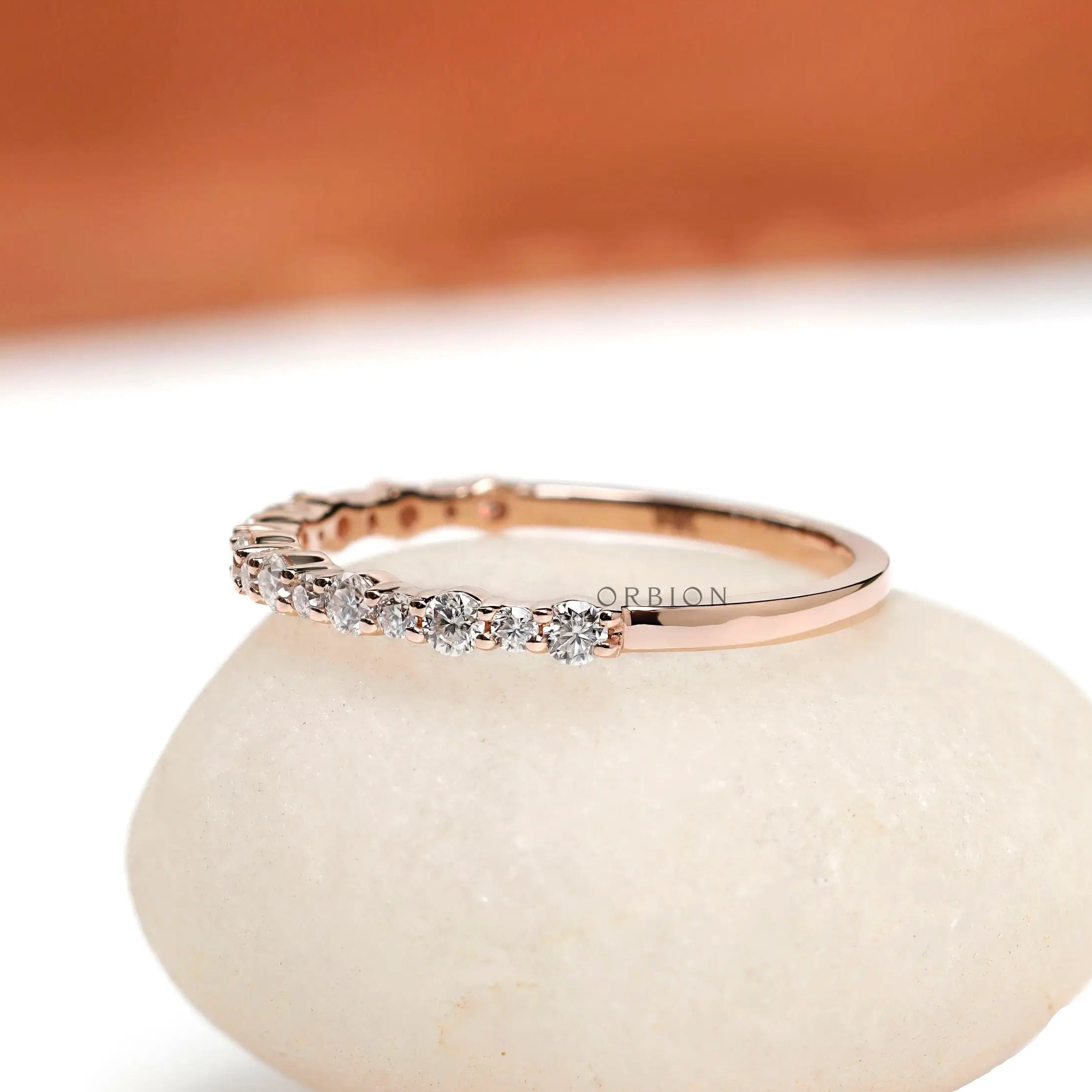 Angled view showing slim round cut moissanite setting