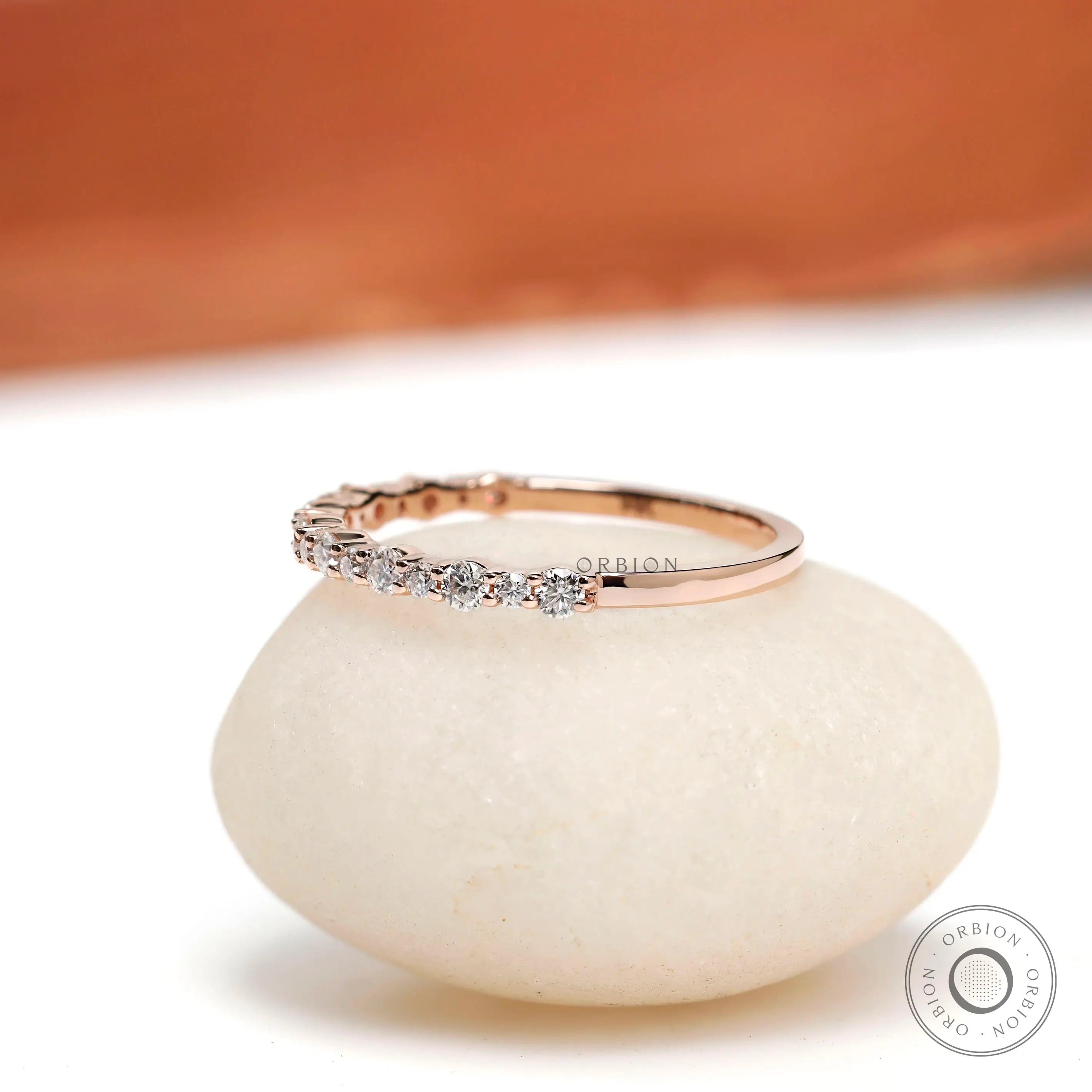 Angled view showing slim round cut moissanite setting