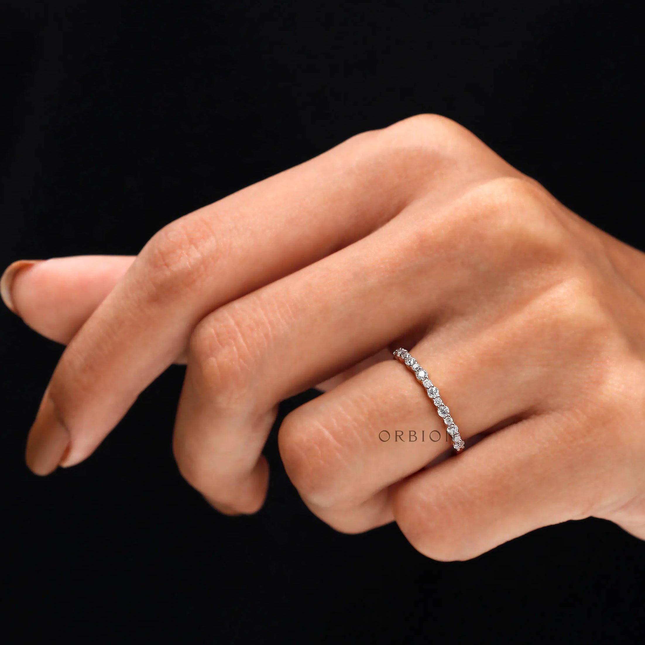 On hand view of minimalist stacking moissanite ring