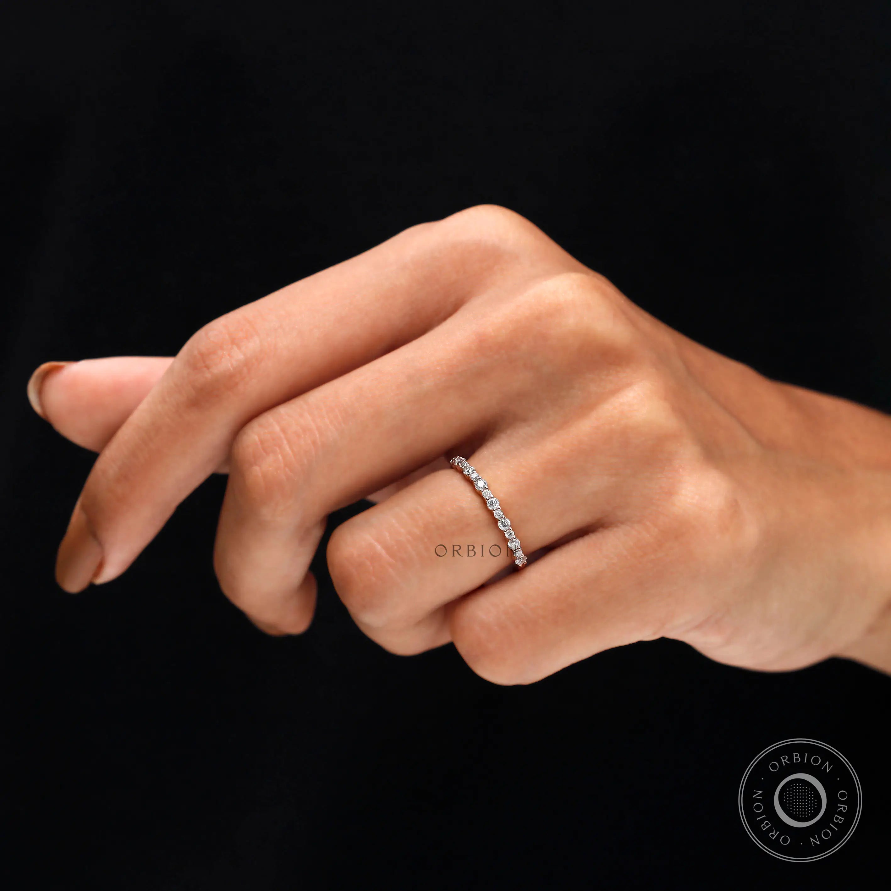 On hand view of minimalist stacking moissanite ring