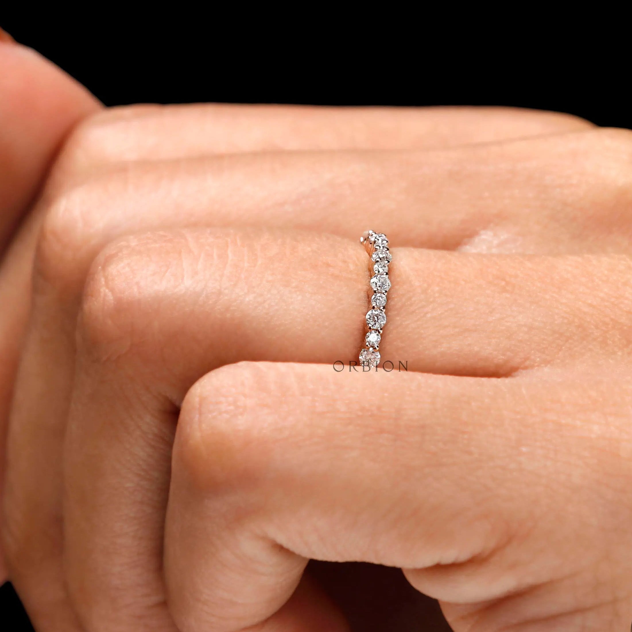 Close-up worn shot showing round cut moissanite sparkle