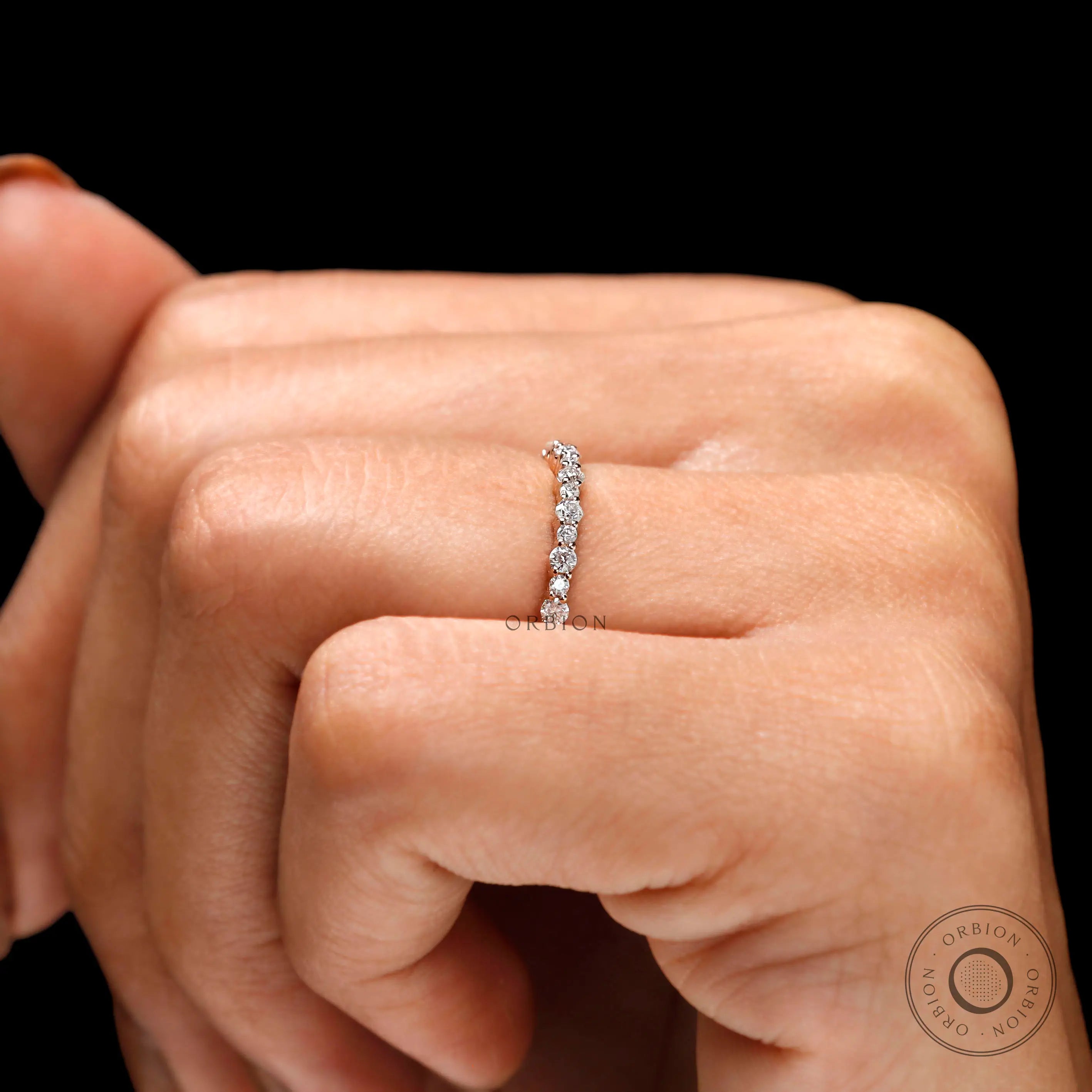 Close-up worn shot showing round cut moissanite sparkle