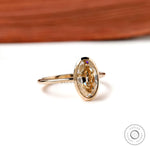Angled view oval champagne bezel solitaire ring in yellow gold