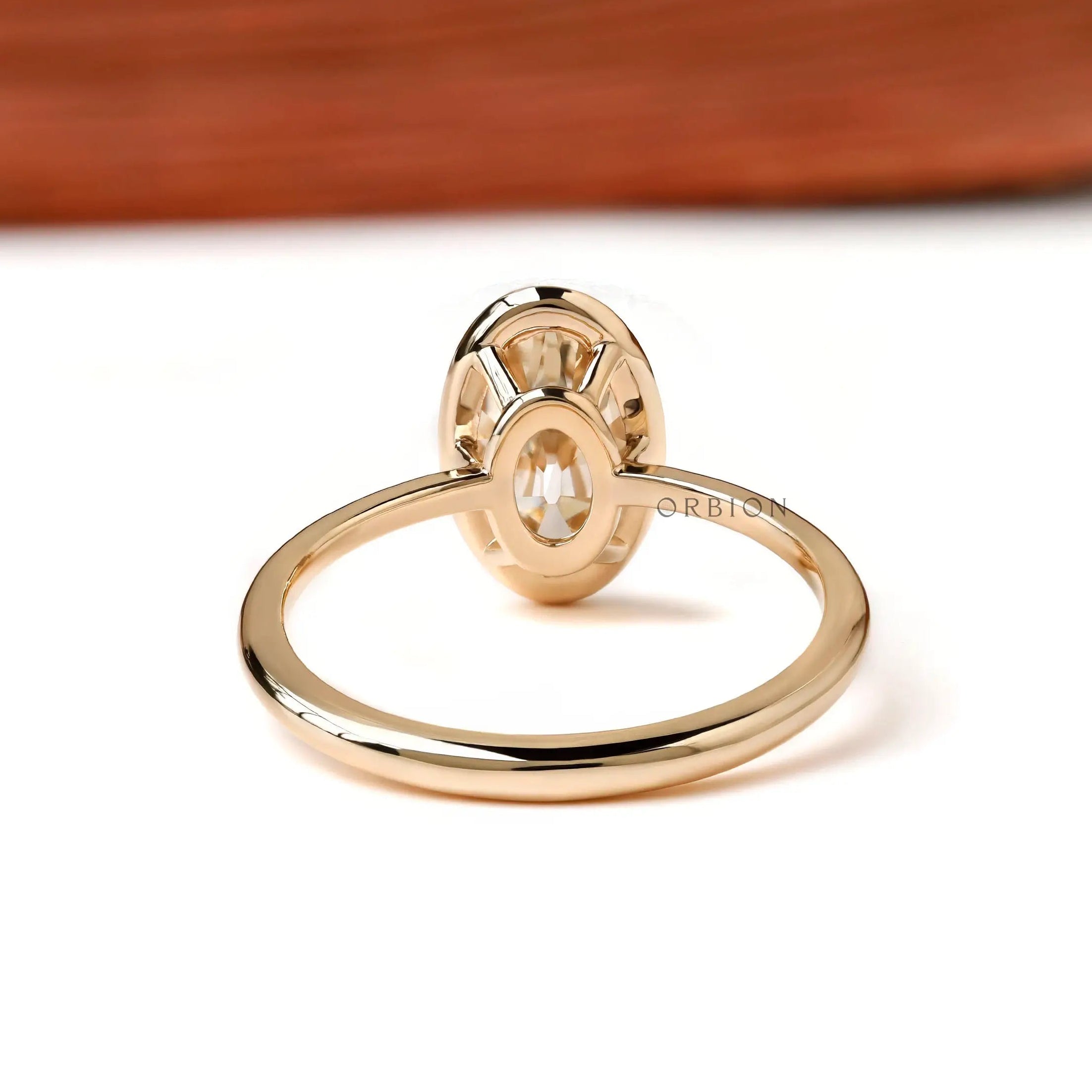 Back view open gallery oval bezel ring in yellow gold