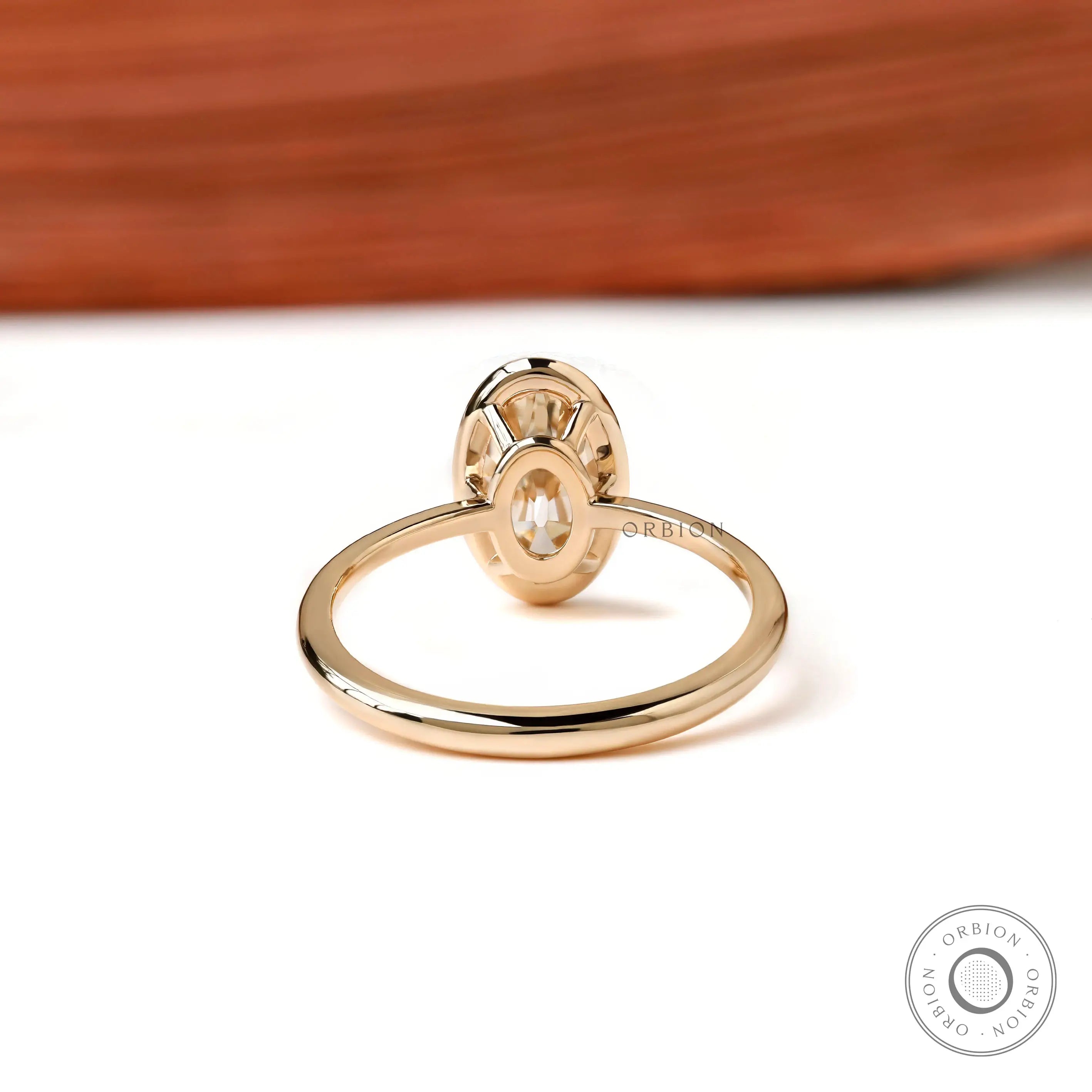 Back view open gallery oval bezel ring in yellow gold