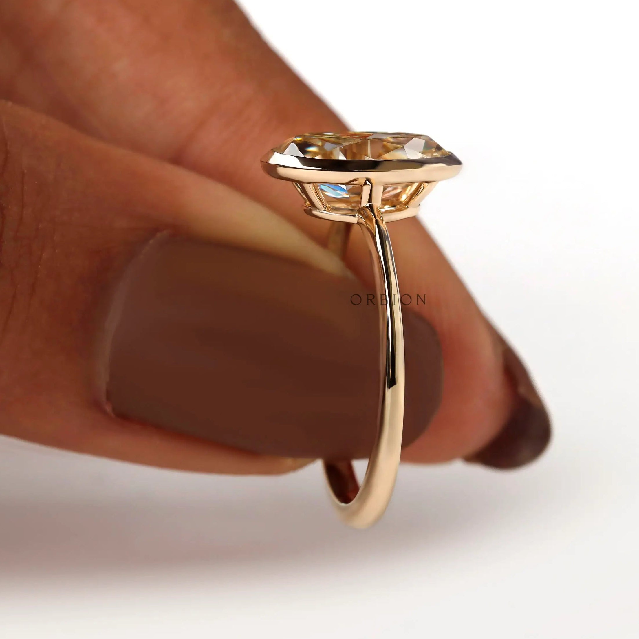 Hand held side view showing low profile oval bezel