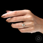 On hand lifestyle view oval champagne bezel ring in yellow gold