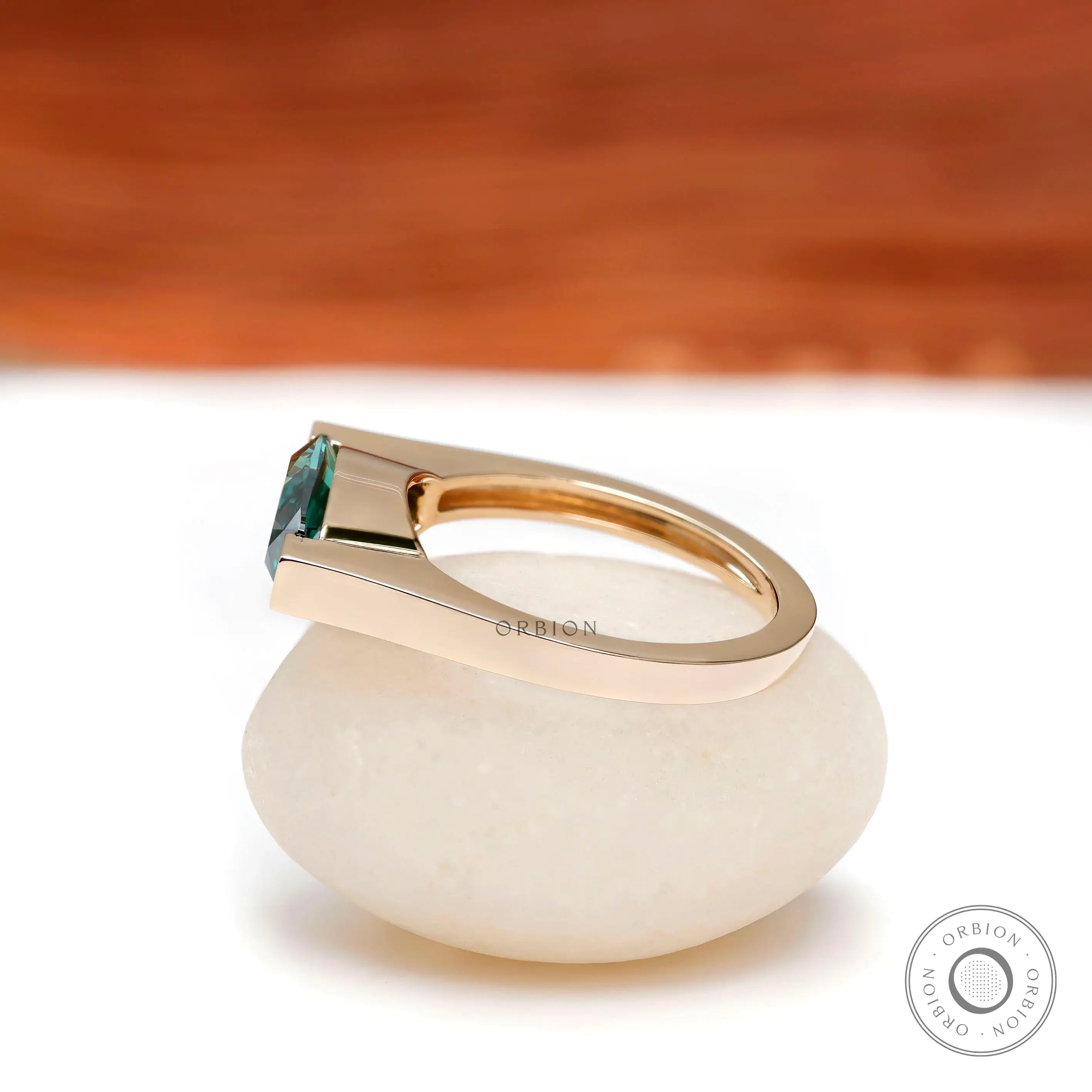 Side profile view highlighting the low-set modern structure yellow gold band.