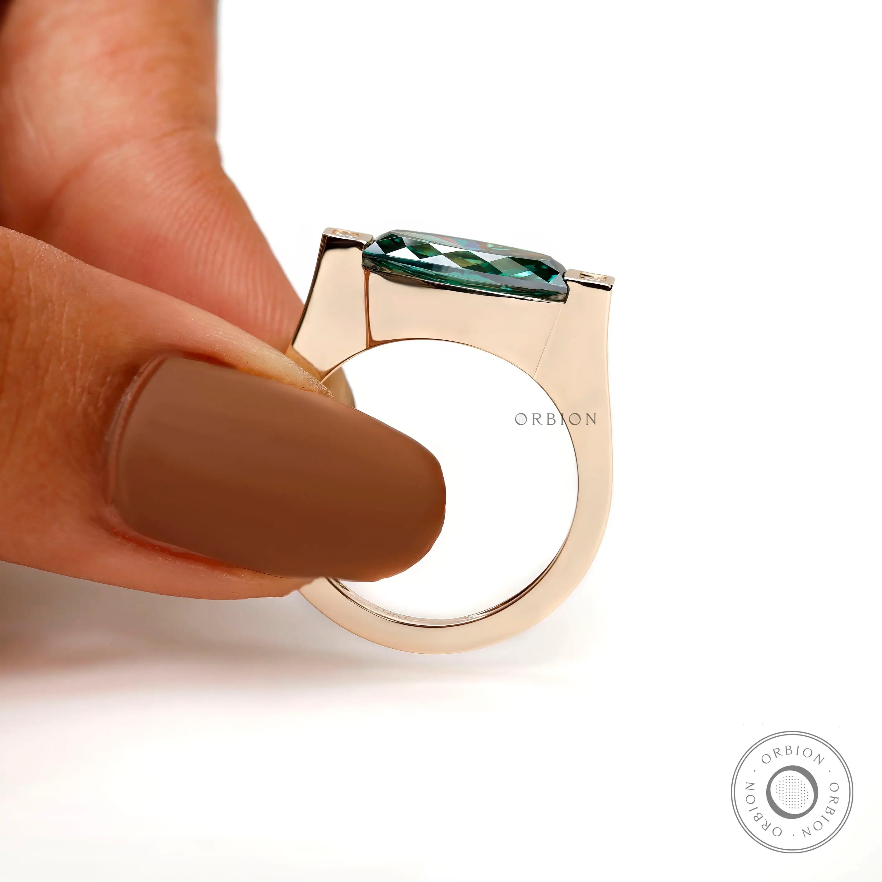 Hand-held side view demonstrating ring height, sleek gallery, and horizontal orientation.