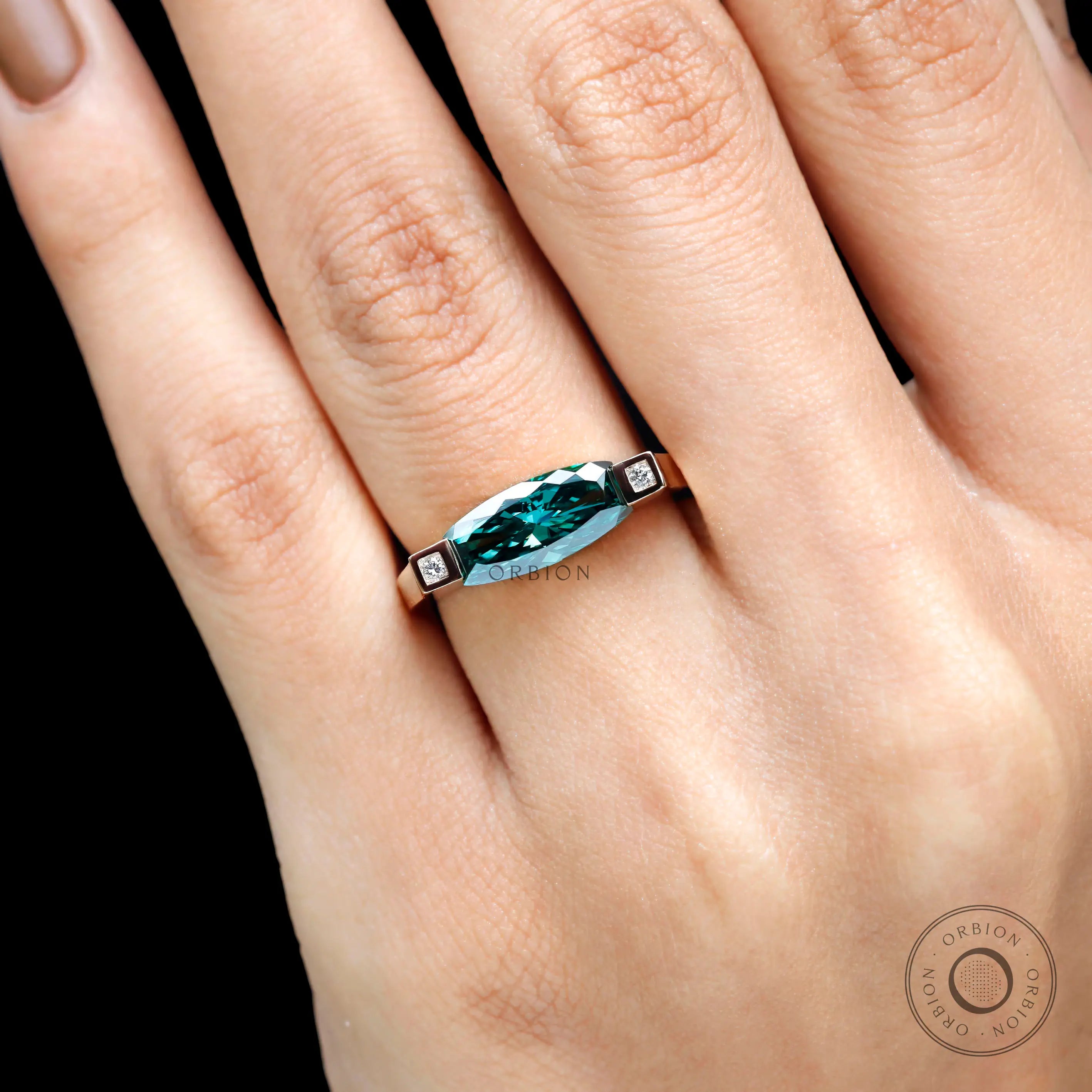 On-hand close top view highlighting refined edges, and elongated silhouette.