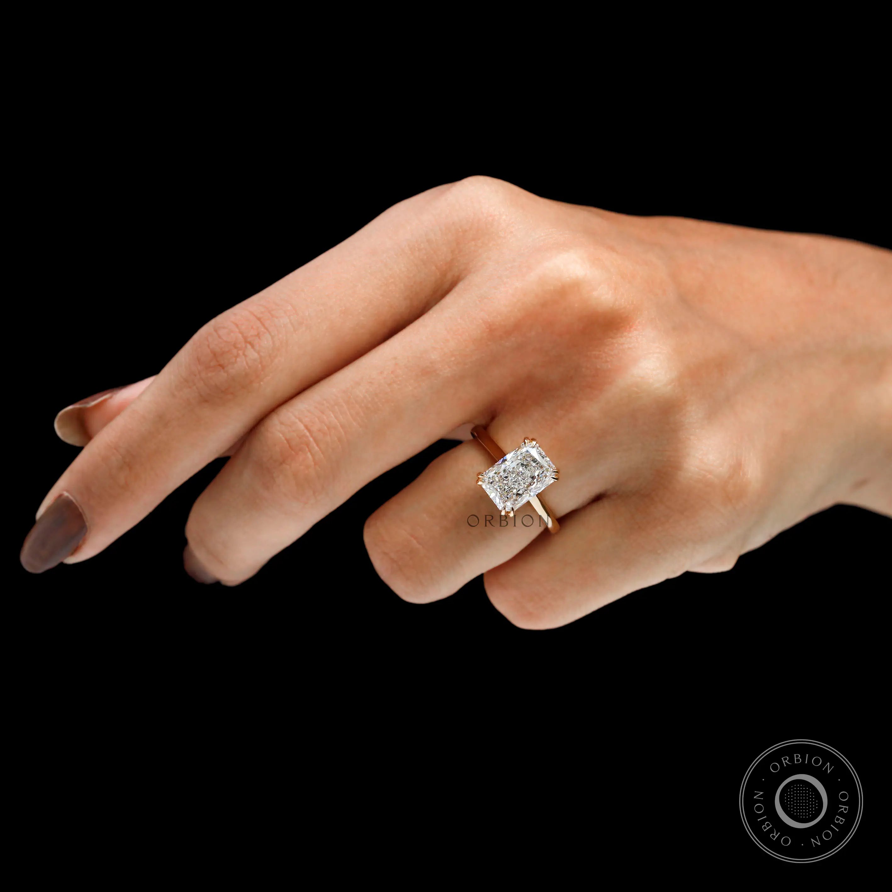 Solitaire radiant cut moissanite engagement ring on hand